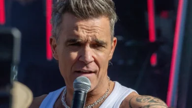 Robbie Williams volta ao Brasil após vinte anos e cobra convite para o Rock in Rio